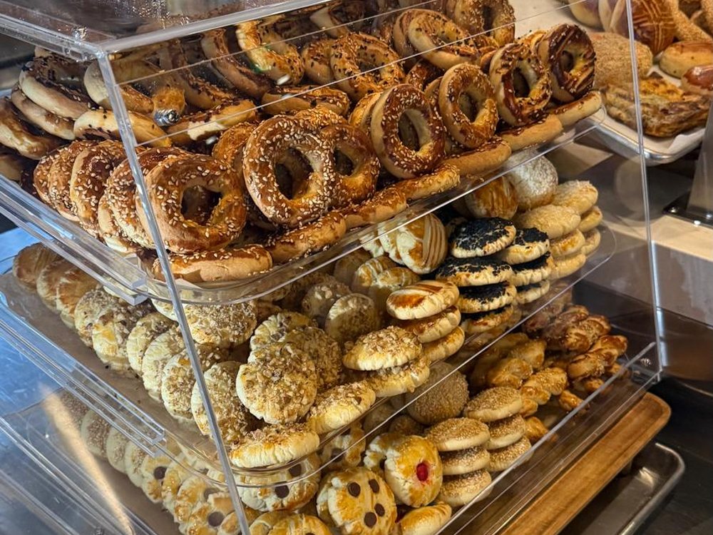 Bakery display case filled with simit, poğaça and pastries