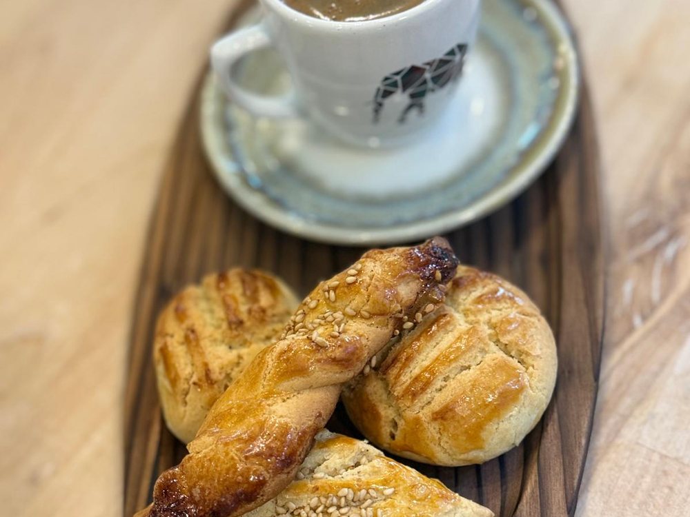 Turkish coffee served on a wooden board with pastries
