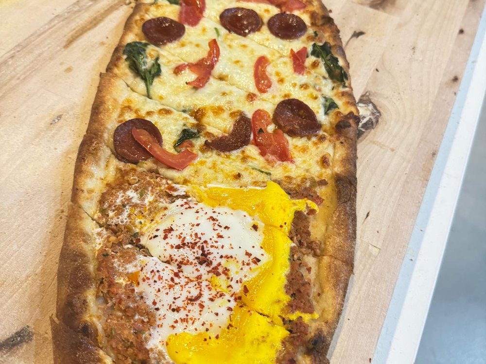 Sucuk and egg pide on a board